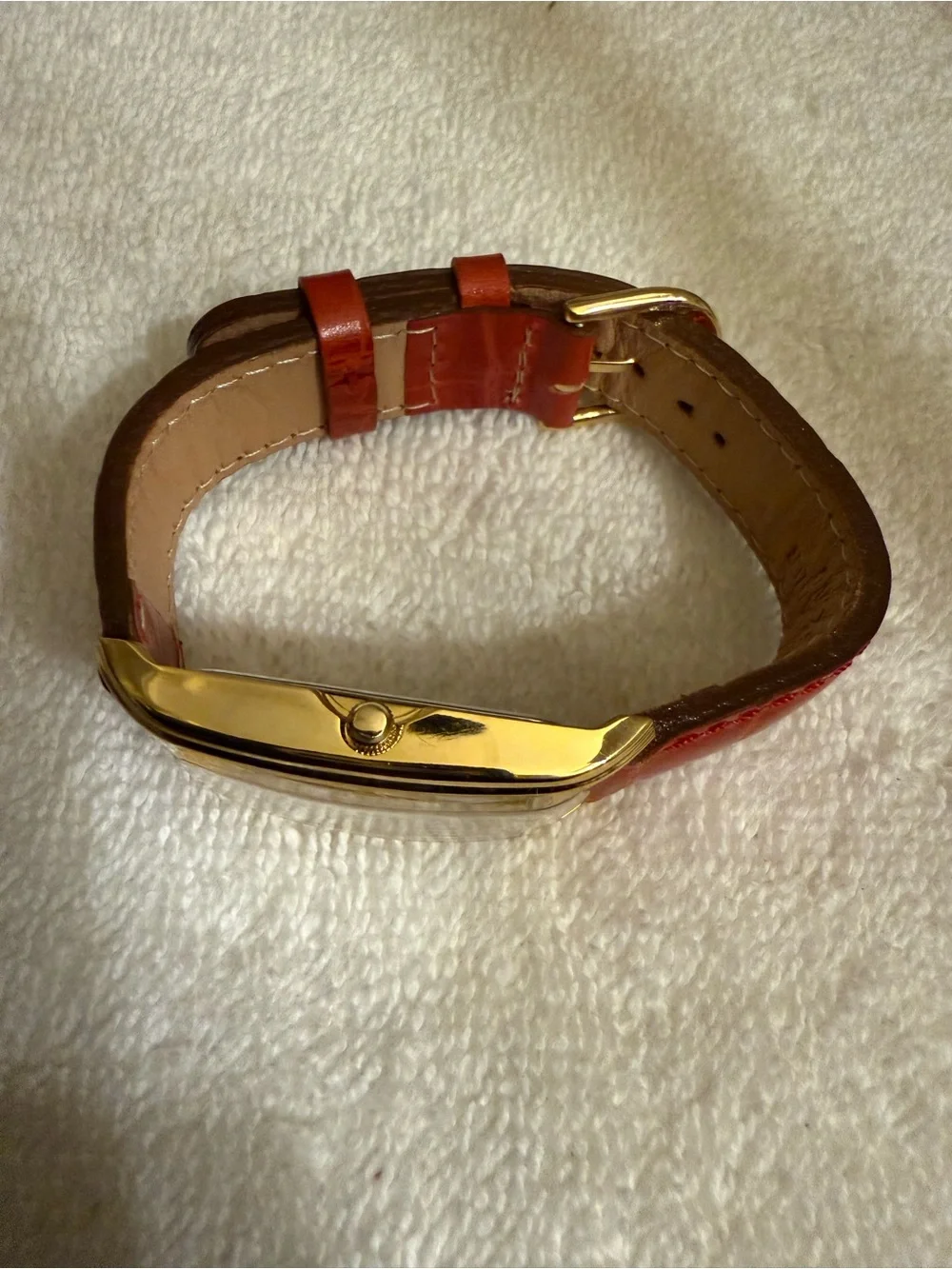 Clarins Gold-Tone Rectangular Watch with Red Strap and White Dial